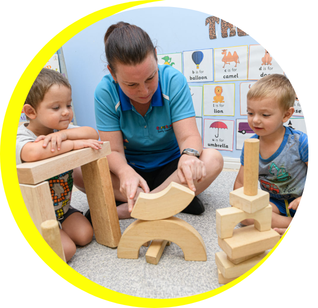 Kindergarten teacher and two kids engaged in play based learning